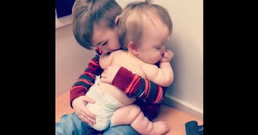 Sick Little Girl Is Comforted By Her Big Brother At The Doctor's Office