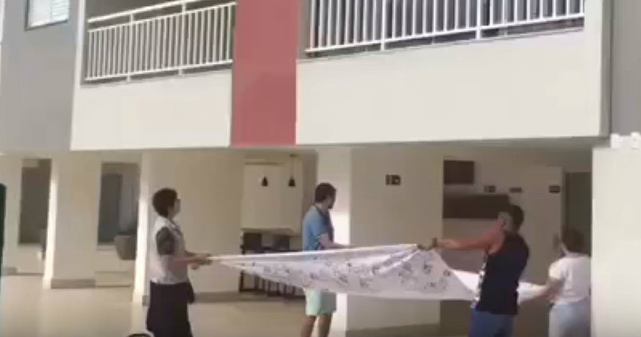 They Grabbed A Sheet To Save A Dog Falling From The Side Of An Apartment Building