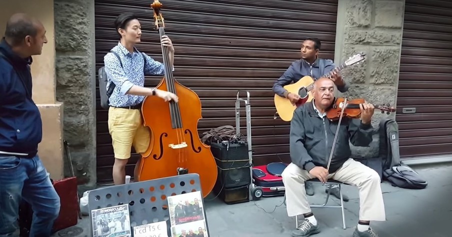 Tourist Plays With Jazz Street Musicians in Florence Italy