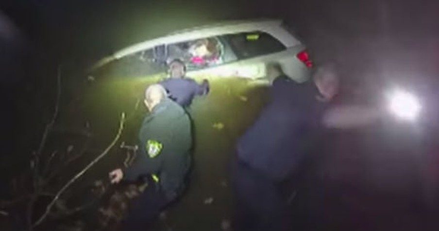 Police Officers Form Human Chain To Rescue Woman From A Sinking Car