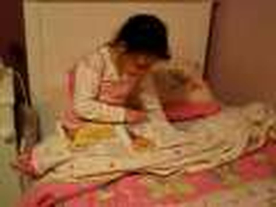 Mia listening to the audio and reading the text of my book