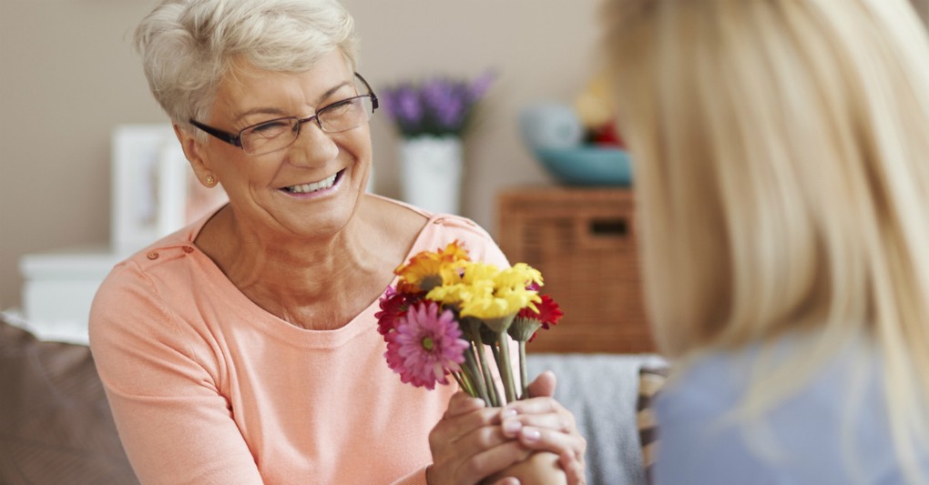 senior woman accepting flowers, ways God tells you how much you matter