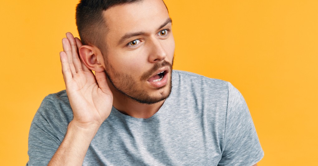 man leaning forward to listen intently