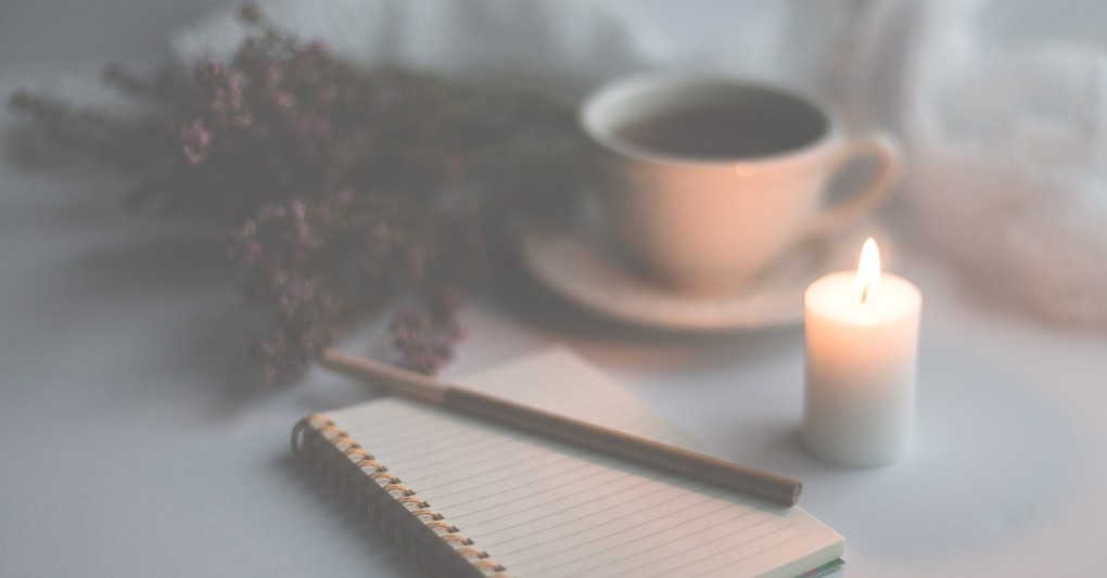 Pen and notebook for journaling with a cup of coffee