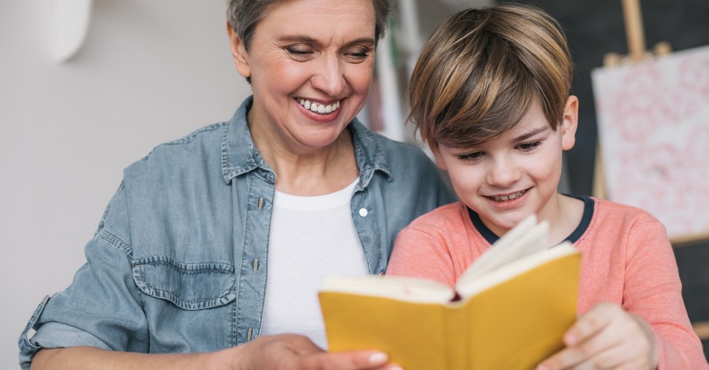 Grandmother and grandson reading a book together