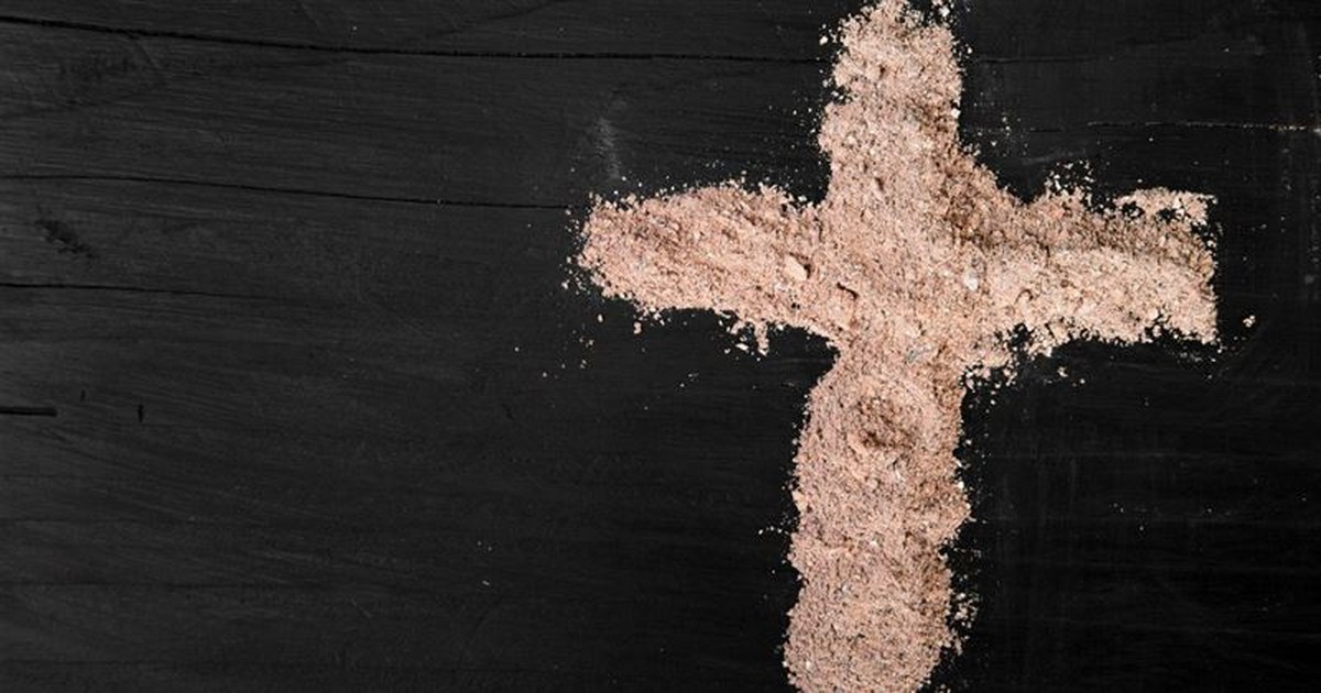 ash Wednesday ashes in shape of cross on table