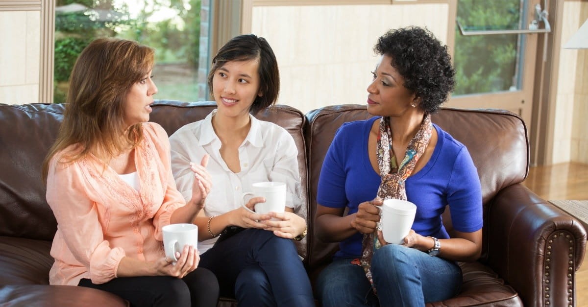 Women talking on a couch, progressive christianity feelings over doctrine