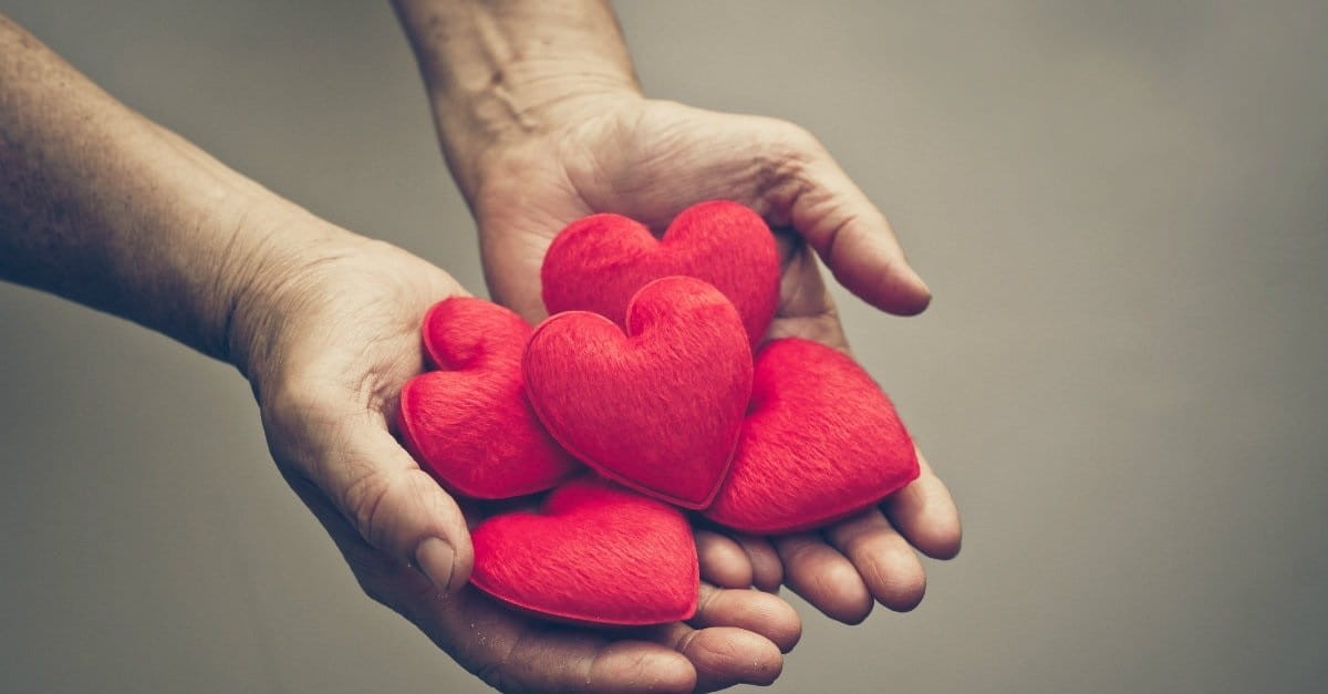 Hands holding a collection of heart cushions Photo Credit: ©Thinkstock