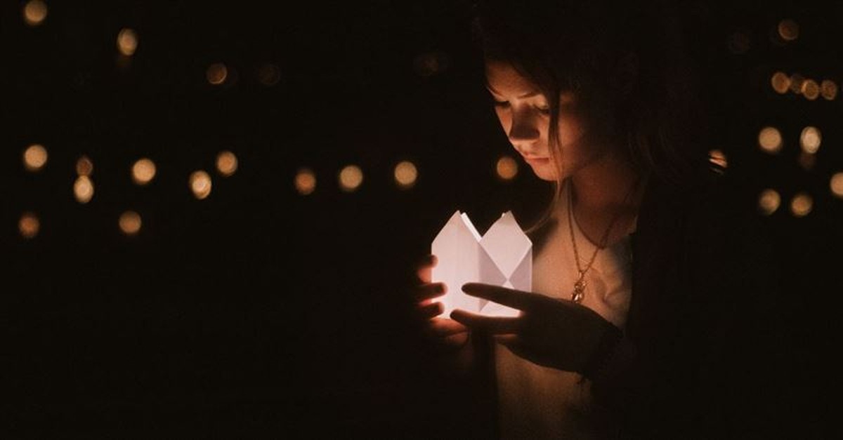 woman holding paper lantern outside