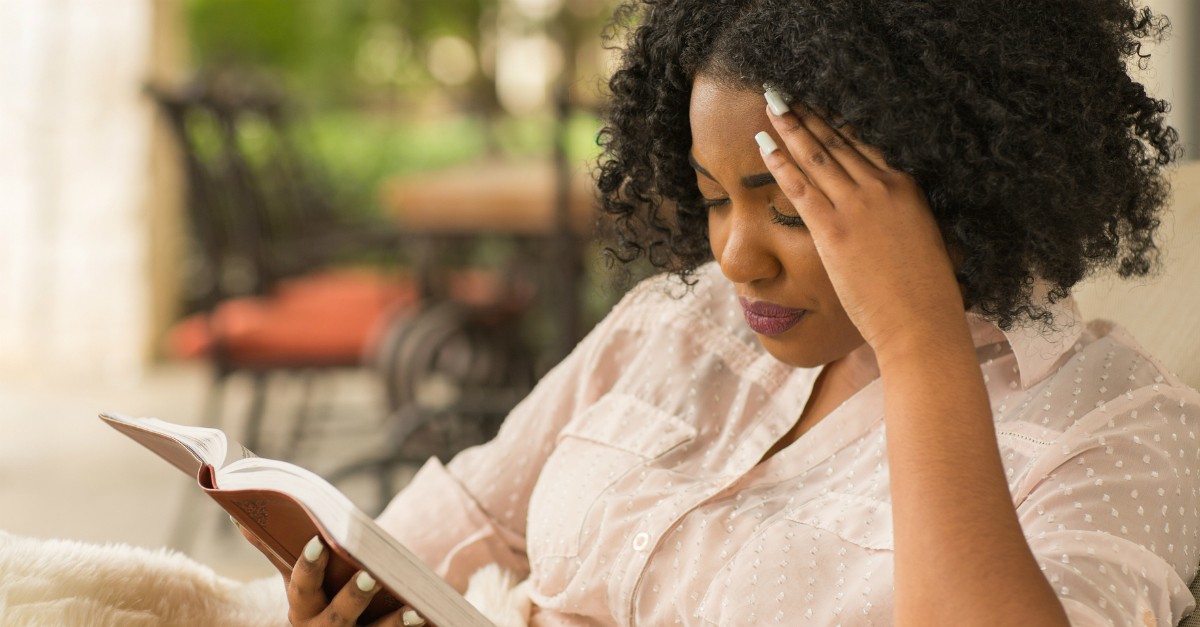 stressed or tired woman reading her bible