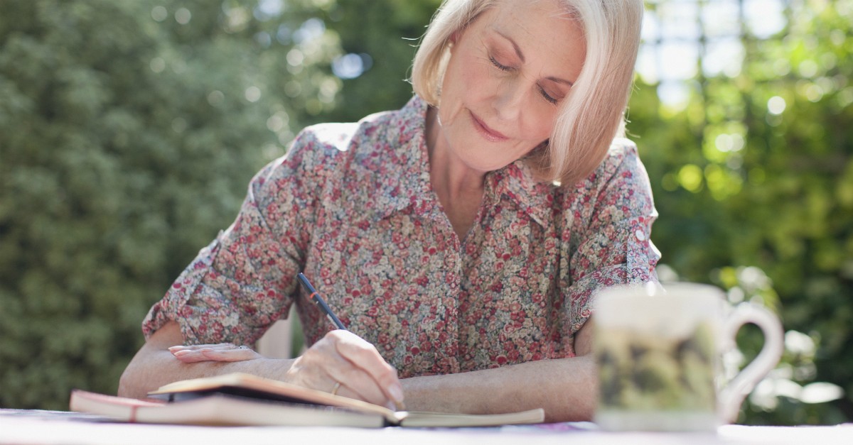 woman sitting outside journaling