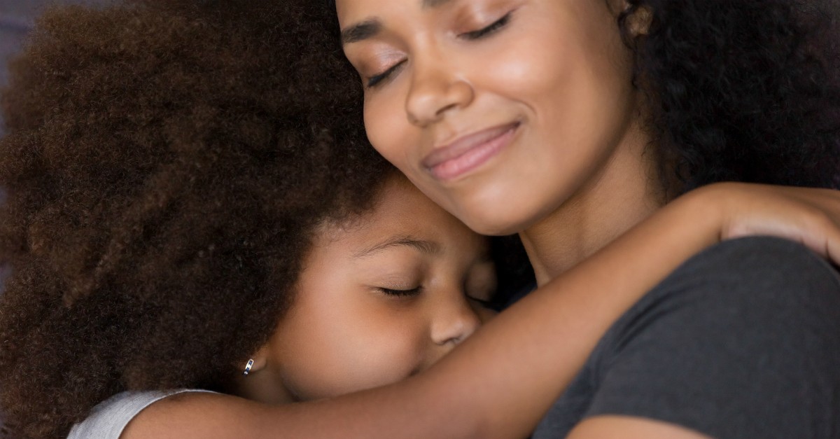mother embracing daughter in happy hug, prayers for children's protection