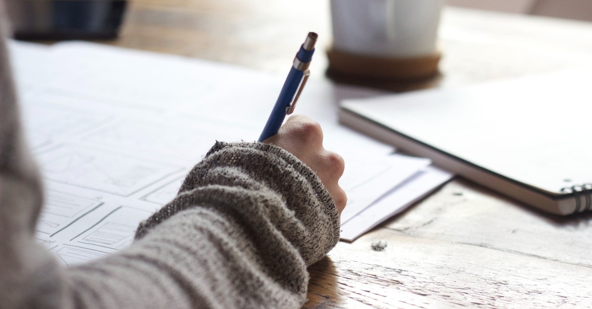 Woman journaling with a pen