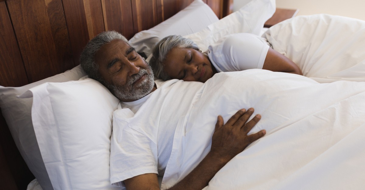 senior couple sleeping in bed