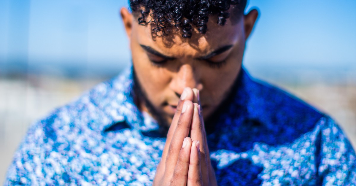 man head bowed praying