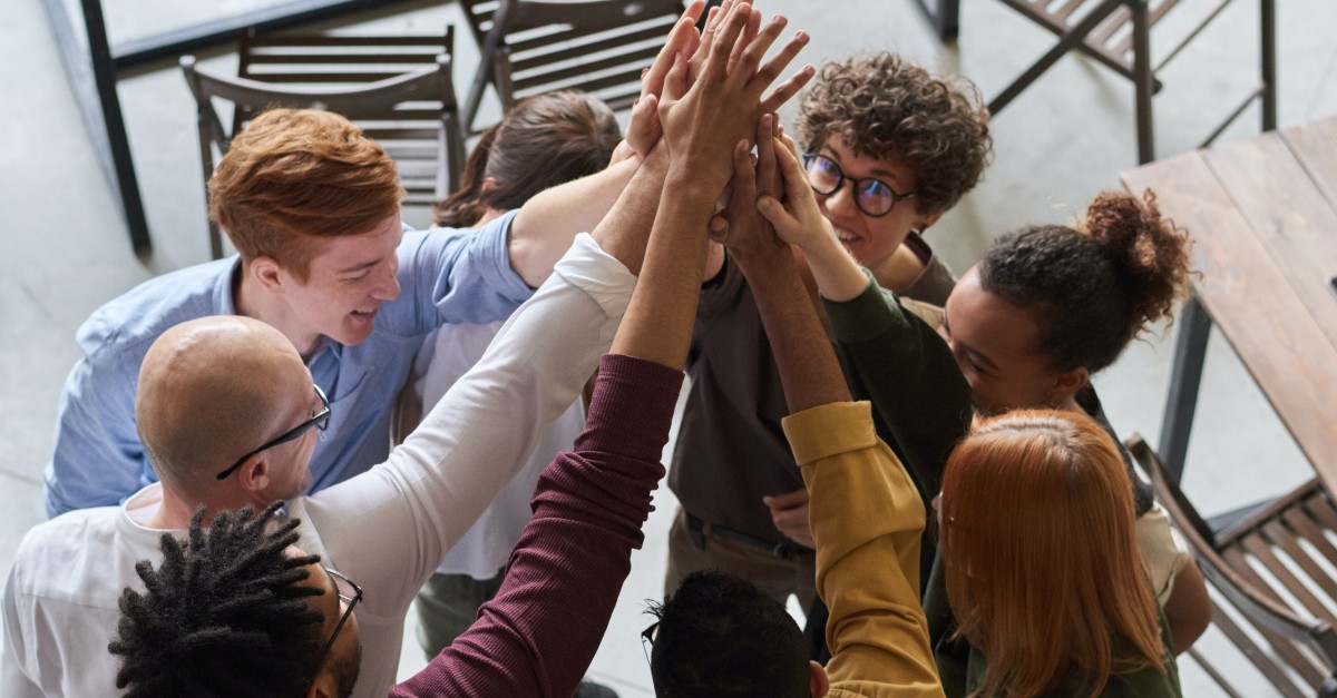 diverse groups of multicultural adults in group high-five