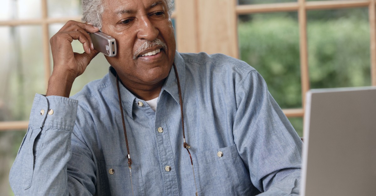 senior man on phone and laptop planning finances