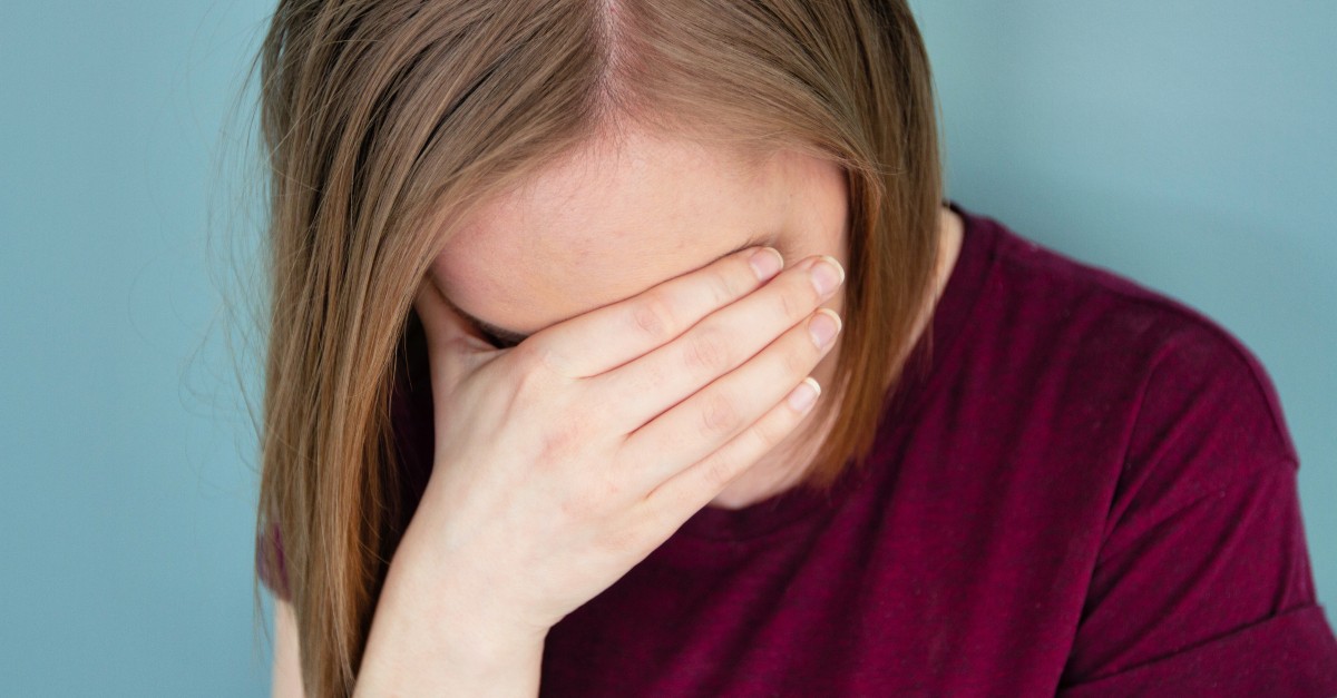 woman feeling shame or sadness covering eyes