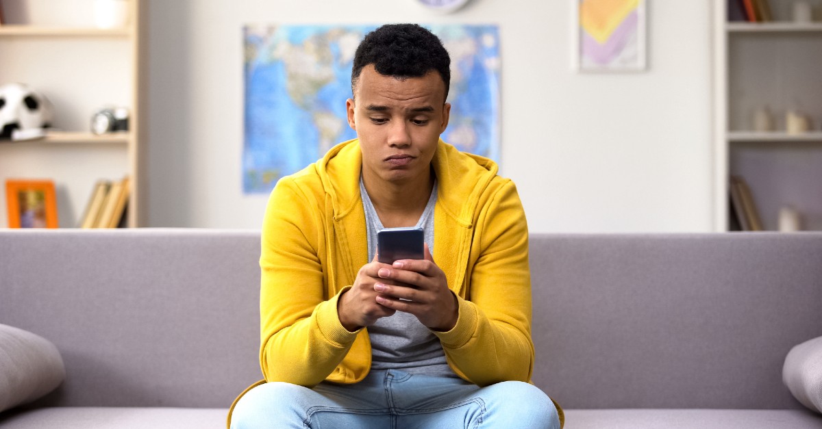 man looking bored while texting