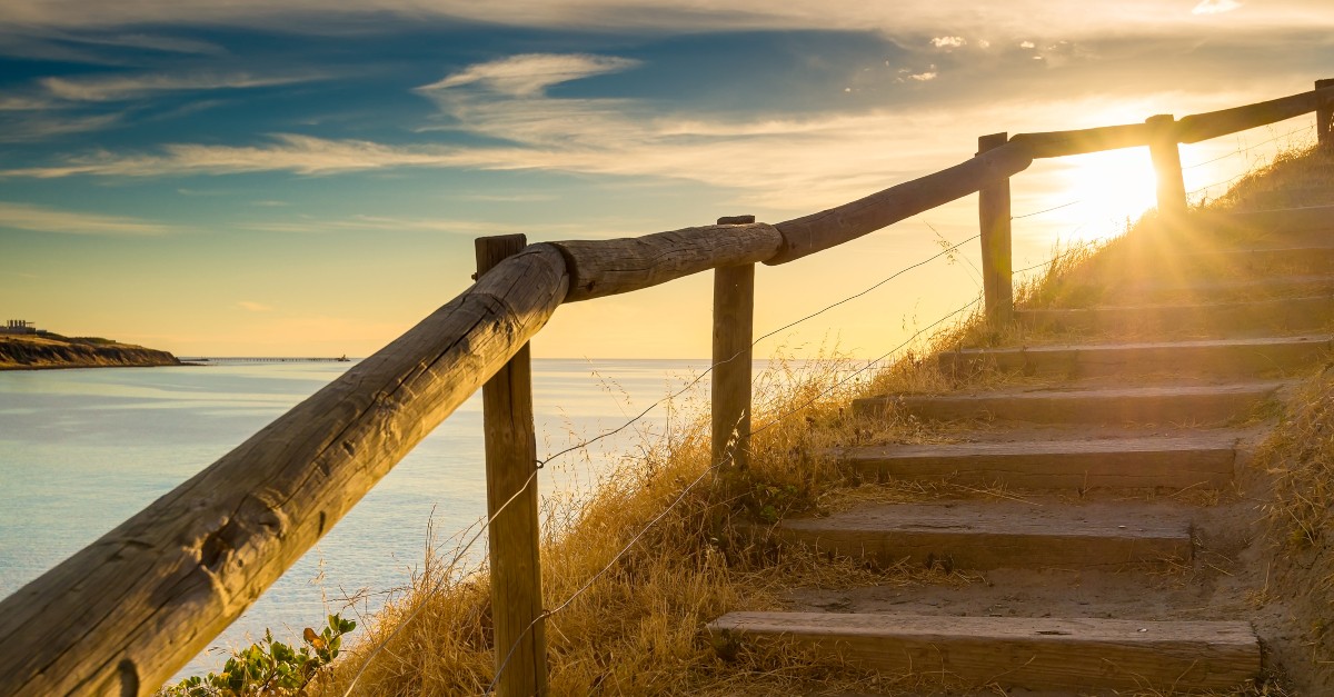peaceful stairway up hill at beach at sunset