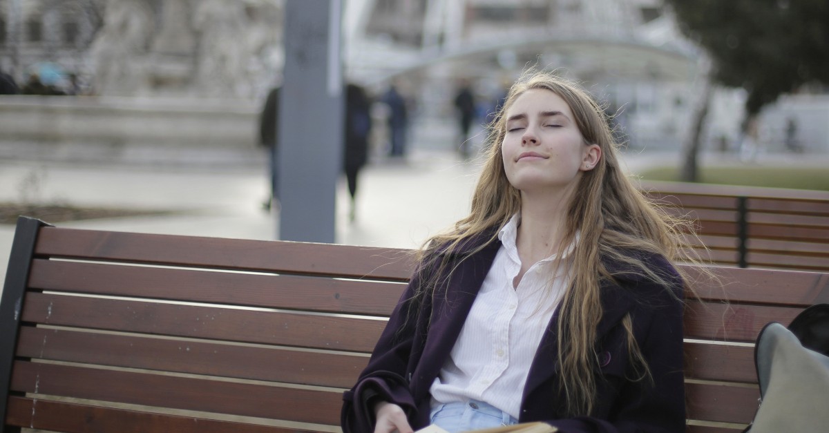 woman relaxing on park bench enjoying sabbath