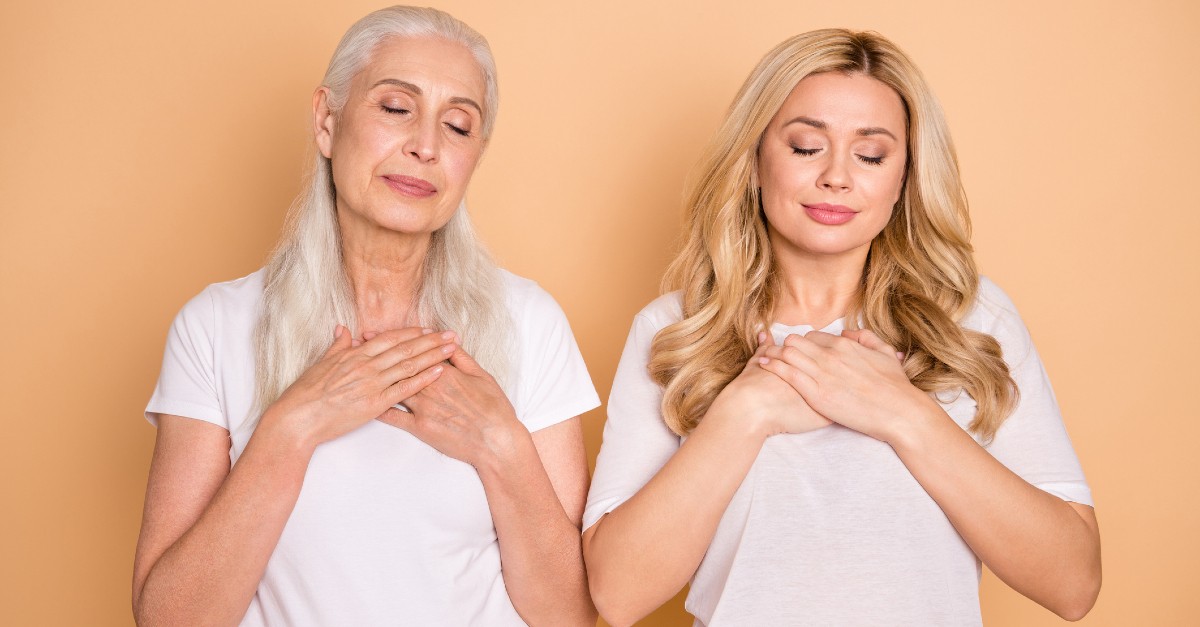 mom and grandma praying next to eachother against orange background