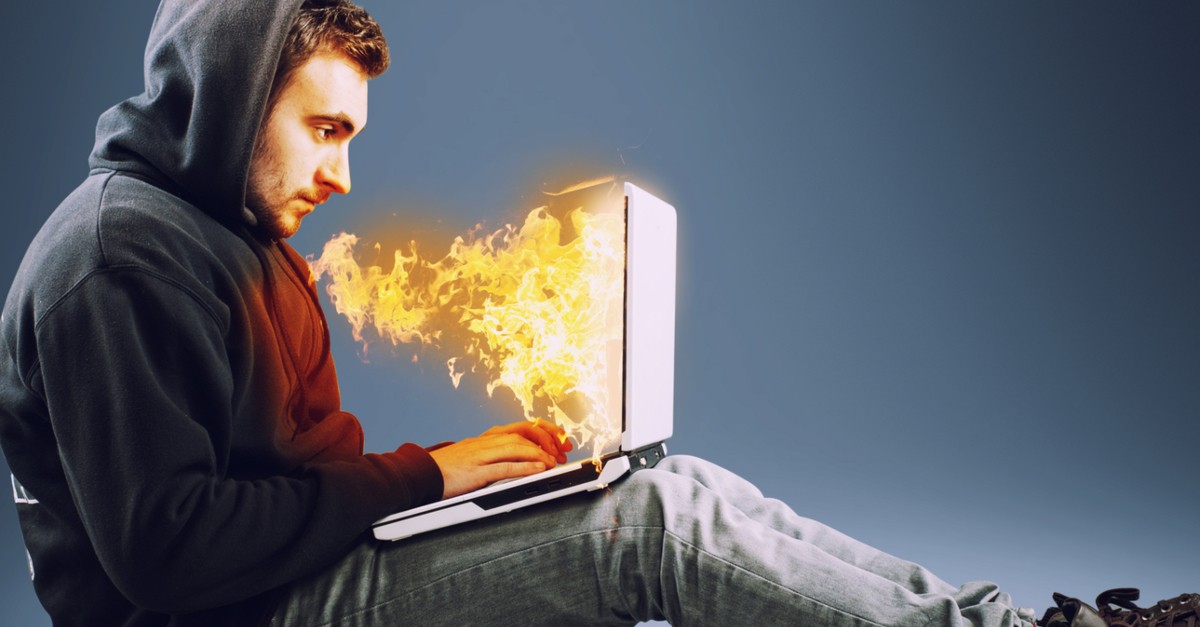 man with laptop on fire satan deceiving through social media