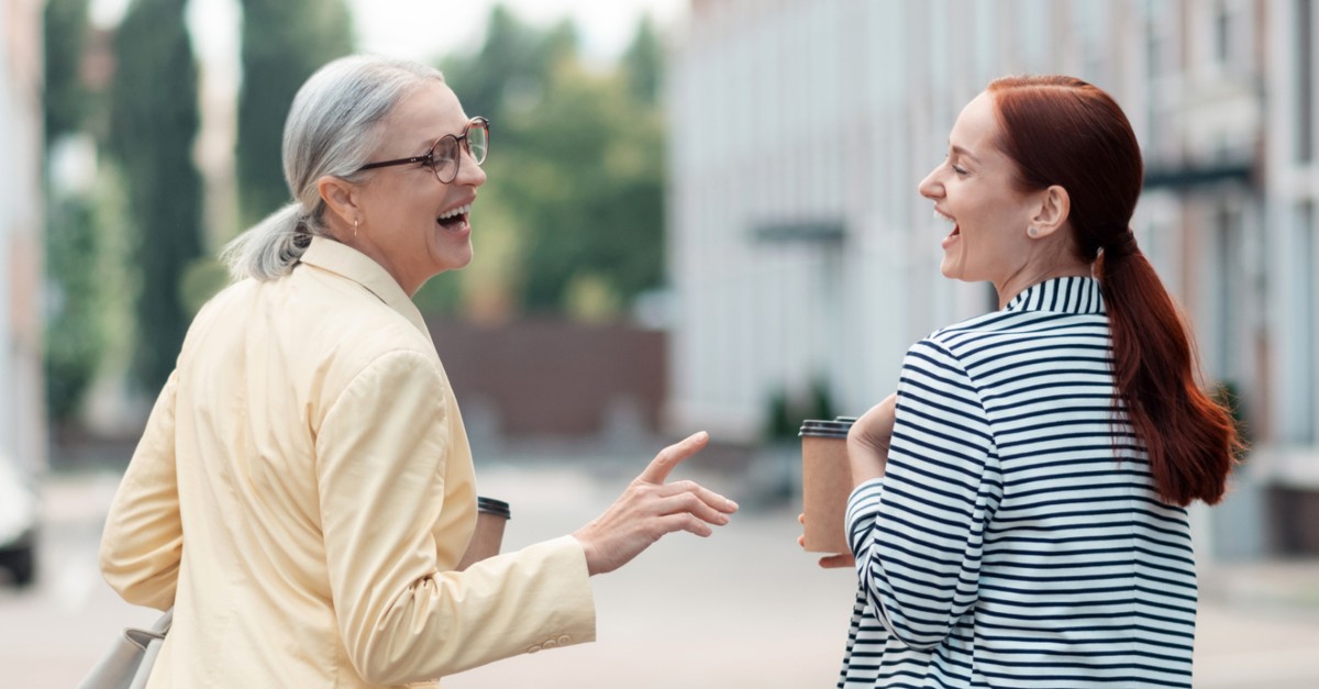 mentor godmother senior woman having coffee with younger woman