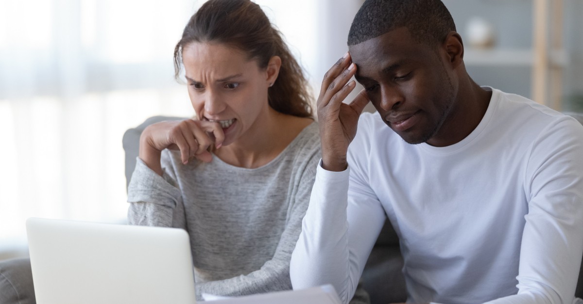 couple stressing over money anxiety at laptop due to COVID-19