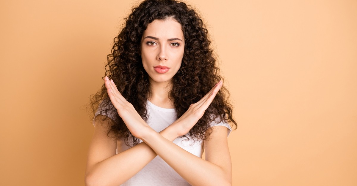 woman forming an ex with her arms, what is cancel culture?