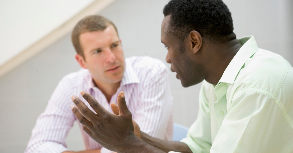 two diverse races men in serious conversation, pastors wish you knew about church covid