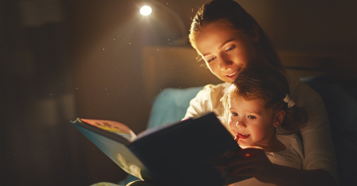 mom reading to kid at bed time