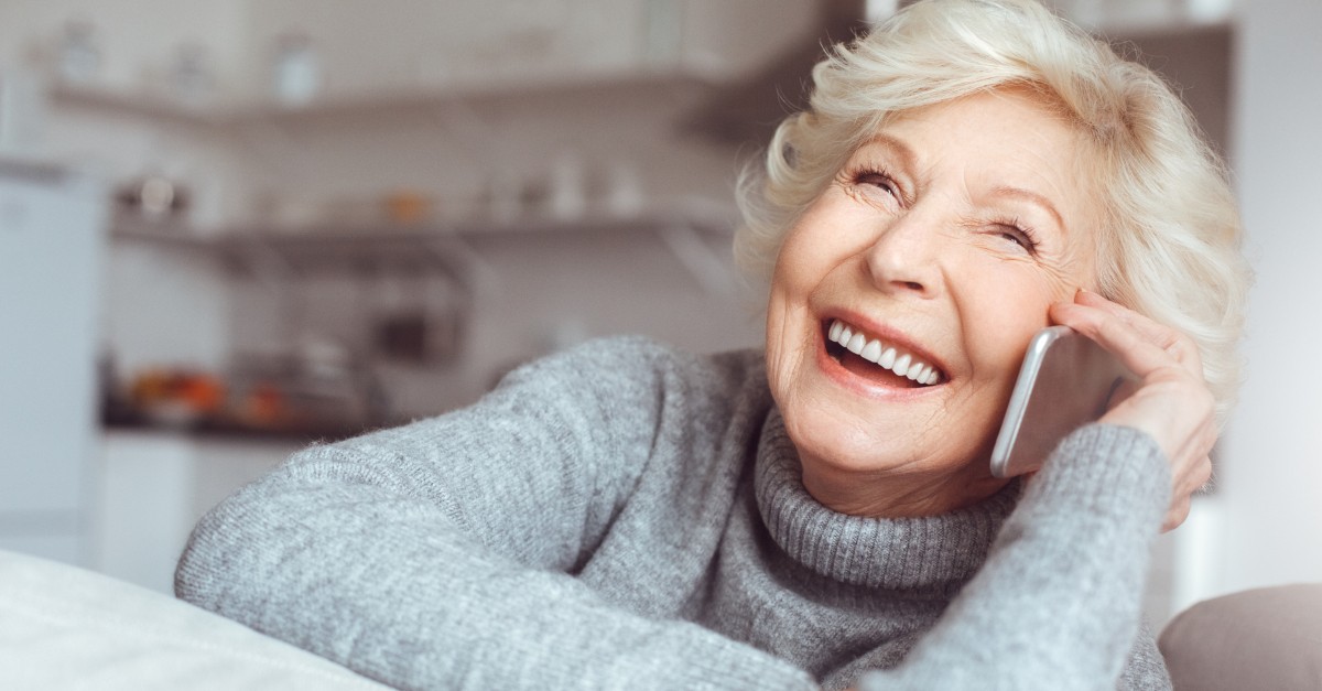 senior woman smiling talking on cell phone smartphone