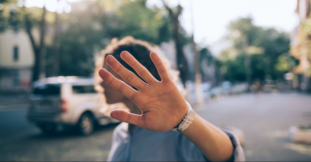 Woman holding her hand up in rejection