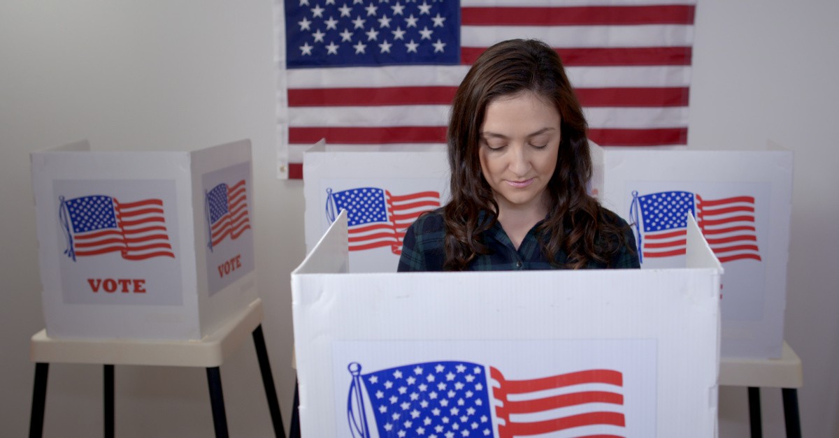 A woman in a voting booth, why voting is so important