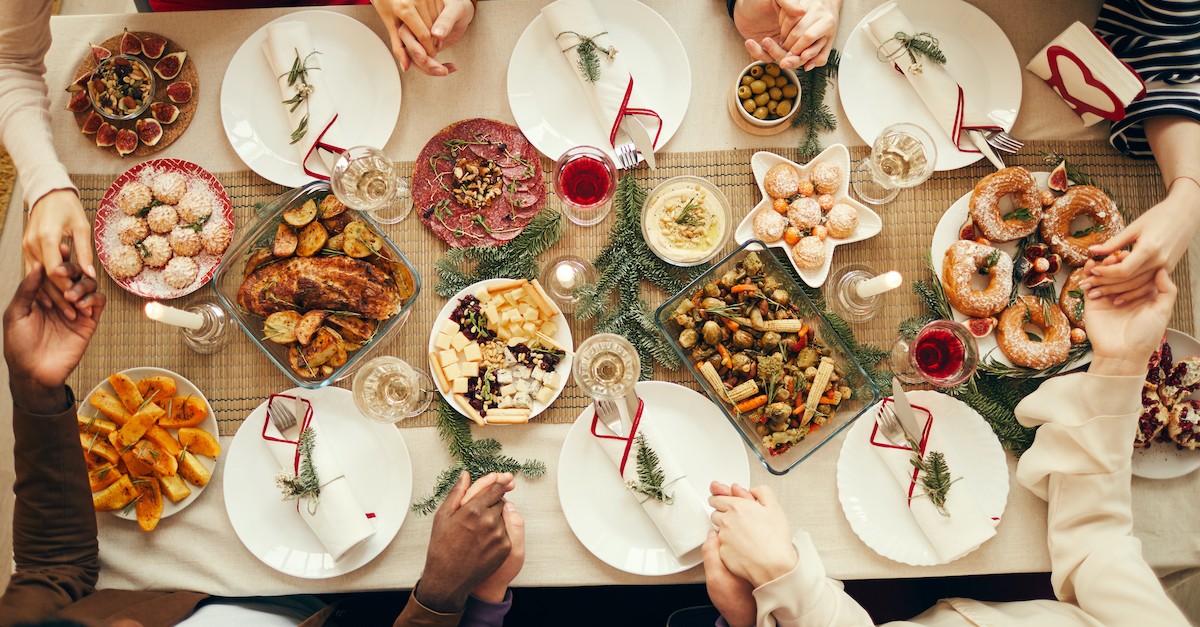 Christmas dinner blessing on decorated table with people holding hands, Christmas dinner prayers