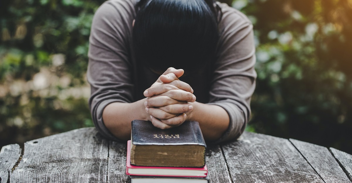 hands folded over bible, bible quotes about strength