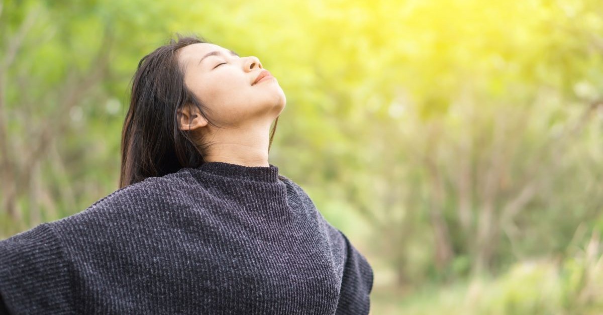 woman eyes closed facing sky