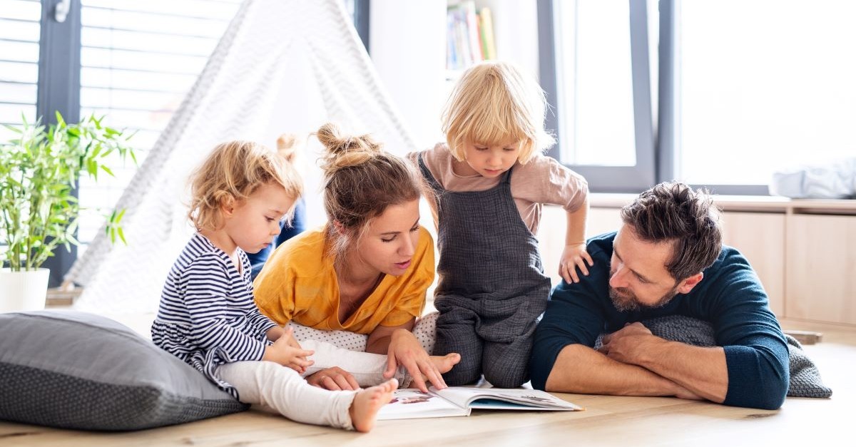 parents with children reading a book
