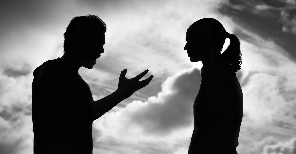 man and woman silhouette having argument, common roots of jealousy in marriage