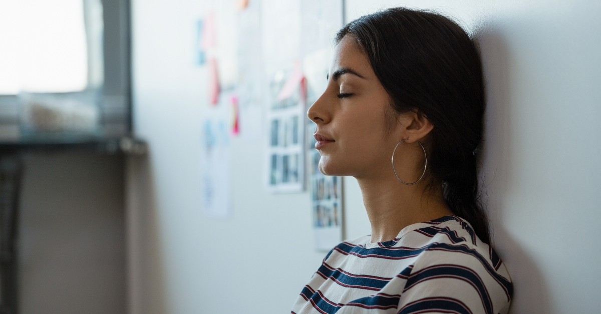 Woman leaning against a wall