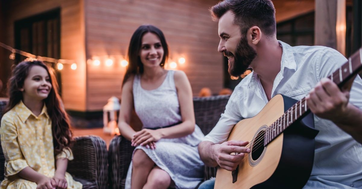 family worship guitar parents daughter sing outdoor patio; what are the most popular father-daughter wedding songs?
