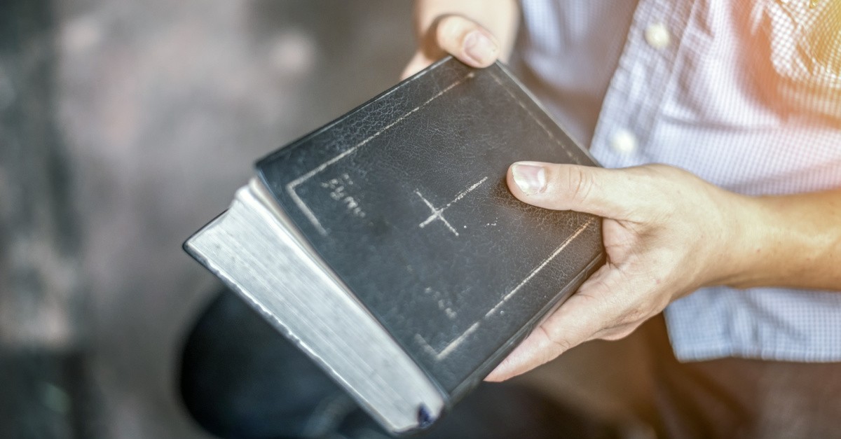 A man holding a Bible