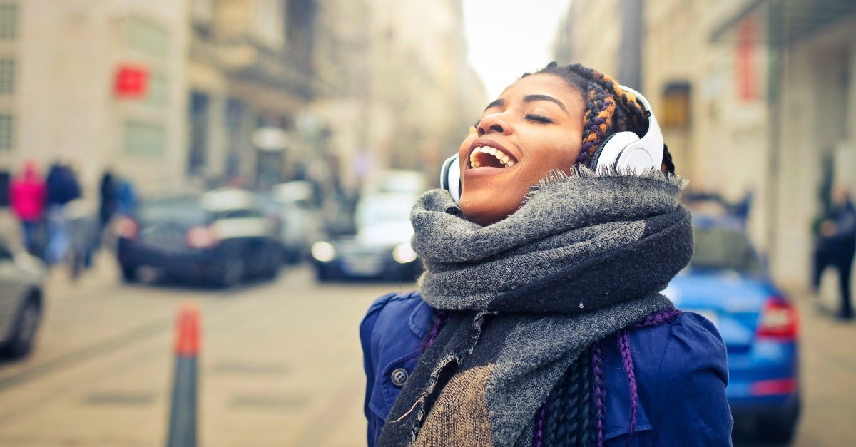 Woman singing while walking down the street