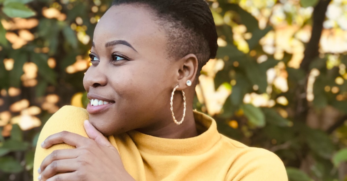 Happy woman hugging herself; focus on personal growth. 