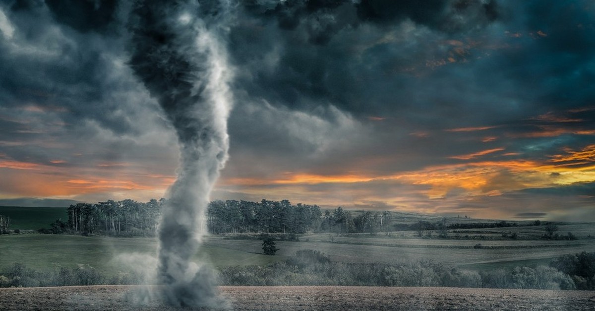 Tornado blowing through a field