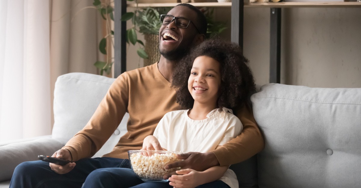 a dad and daughter watching a movie, Inspiring Movies about Dads for Father’s Day