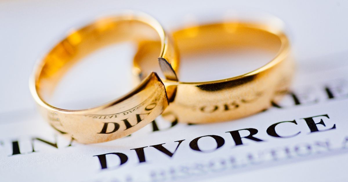 Broken wedding rings on divorce papers