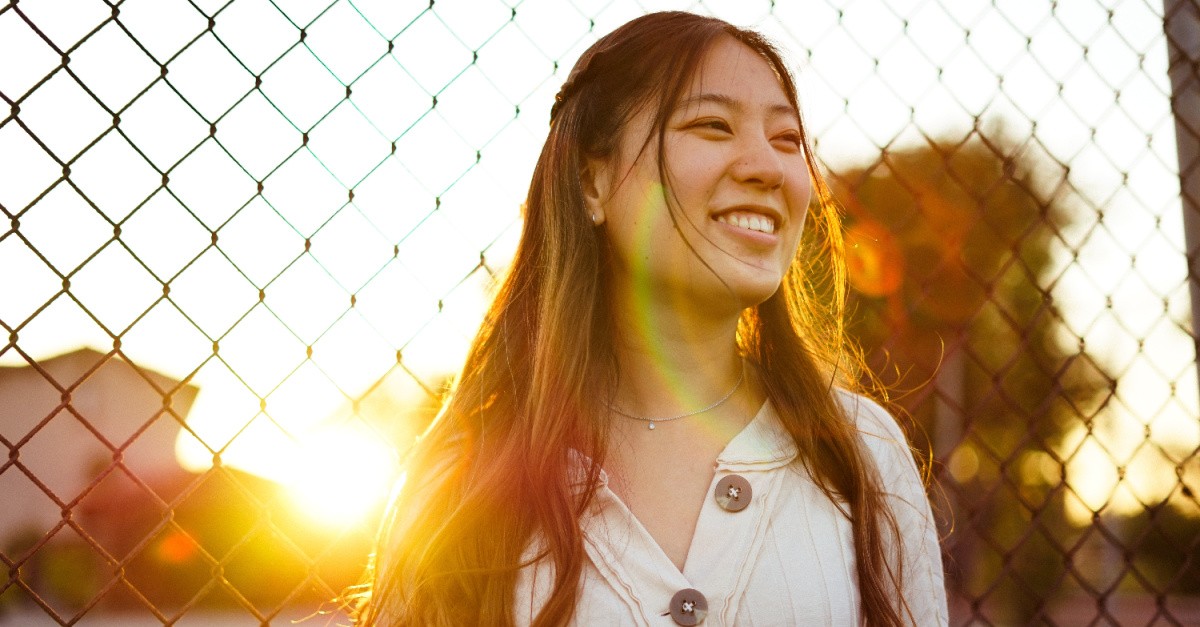 A smiling girl; practice self-compassion. 