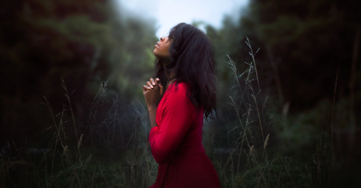 a woman praying, why we must open ourselves up to God